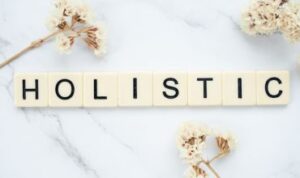 banner holistic in letter tiles with flowers for natural care by Veusebeia